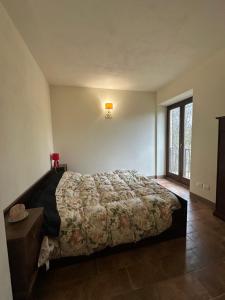 a bedroom with a bed in a room with a window at Da Taz Siena in Siena