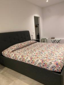 a bedroom with a bed with a colorful comforter at Loft 33 in Milan