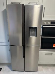 two stainless steel refrigerators are in a kitchen at The Peacock House 7 mins from Luton airport in Luton