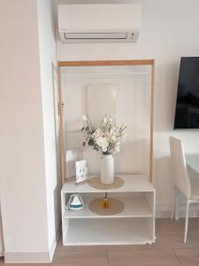a vase of flowers on a table in a room at SARA RIVIERA Costa Plana in Cap d'Ail
