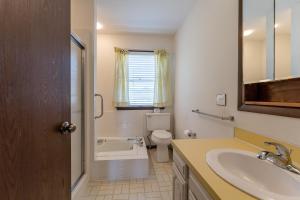 a bathroom with a toilet and a sink at Beachfront cottage on North Shore Grand Haven in Spring Lake +25 photos