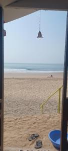 a view of the beach with a pair of flip flops at Nana's Nook in Agonda +16 photos