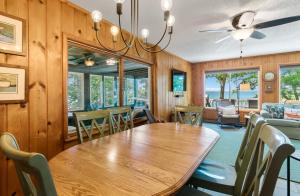 a dining room with a wooden table and chairs at Whiskey Creek Cottage- Private Lake Michigan Beach Frontage in Rothbury
