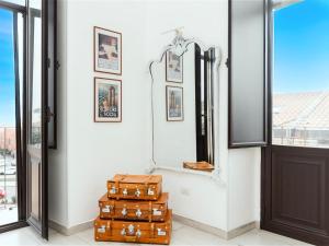 a room with luggage and a mirror and a door at Catania City Lodge - Free Parking - Next to Metro in Catania +16 photos