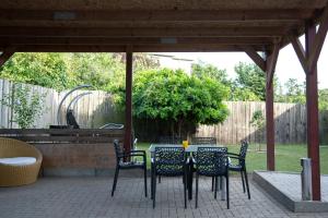 a patio with a table and chairs under a pavilion at Lemsdorfer Apartments Magdeburg in Magdeburg
