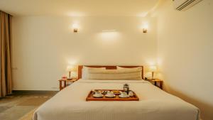 a bedroom with a bed with a tray of food on it at Guldaar Sariska - A Luxury Forest Retreat in Tehla +111 photos
