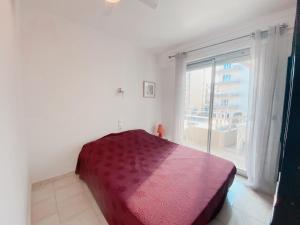 a bedroom with a bed and a large window at Superbe Appartement Vue mer in Canet-en-Roussillon