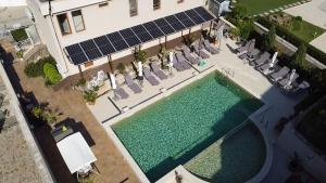 an overhead view of a swimming pool with chairs and a building at Melia Mar in Sozopol