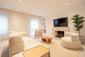 a living room with a couch and a fireplace at Stylish & Spacious Flat near the Beach by HostWise in Matosinhos