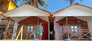 a woman standing in front of a building at Nana's Nook in Agonda