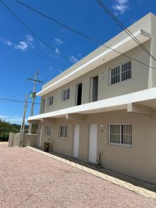 a white house with a driveway in front of it at Loft incrível e completo in São Lourenço do Sul
