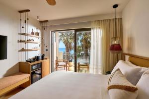 a bedroom with a bed and a view of the ocean at Alai Crete, a Tribute Portfolio Resort in Stalís +50 photos