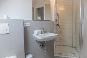 a bathroom with a sink and a shower at Typ C1 Lodge - Napali Coast in Pelzerhaken +5 photos