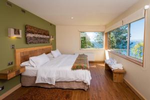 מיטה או מיטות בחדר ב-Hotel Cabaña Del Lago Puerto Varas