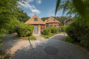 an image of a house with a driveway at Typ C1 Mini Lodge - Mana Point 2 in Pelzerhaken