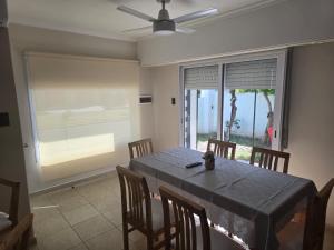 a dining room with a table and chairs and a window at Look Departamentos in Carhué