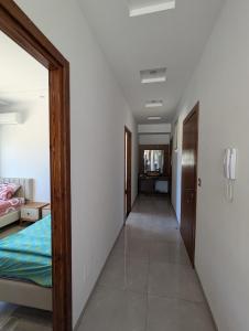 a hallway leading to a bedroom with a bed at Kelibia Beach appartments in Kelibia
