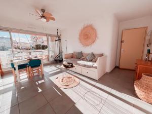 a living room with a couch and a table at Magnifique T2 au calme avec une superbe vue sur le port in Canet-en-Roussillon