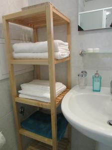 a bathroom with a towel rack next to a sink at Trimarchi House in Naples