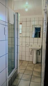 a bathroom with a sink and a mirror at PLANES in Kokstad +40 photos