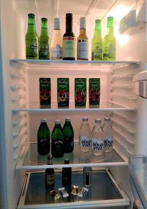 a refrigerator filled with lots of bottles of alcohol at Matija LUX Konaci in Zlatibor