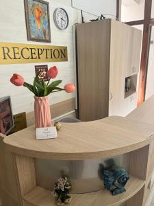 a table with a vase with flowers on it at Melia Mar in Sozopol +74 photos