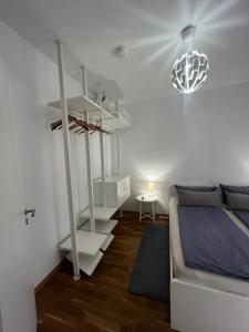 a bedroom with a white bunk bed and a chandelier at Zentrales City-Appartment in Bayreuth