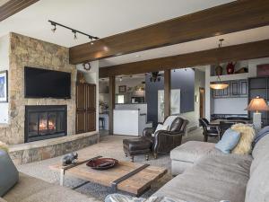 a living room with a couch and a fireplace at Luxury By The Lake in Dillon