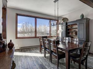 a dining room with a wooden table and chairs at Luxury By The Lake in Dillon