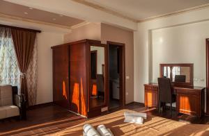 ein Wohnzimmer mit Schreibtisch, Stuhl und Schrank in der Unterkunft Hotel Velkom in Sutomore