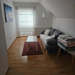 a living room with a couch and a table at Apartman Čardak in Gospić