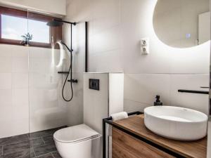 a white bathroom with a sink and a toilet at Bandi Weekend House in Somlójenő +16 photos