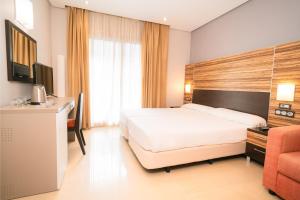 a hotel room with a bed and a desk at Magic Inn in Oropesa del Mar