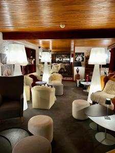 a living room with couches and tables and lamps at Hotel Bel'alpe in Morzine +74 photos