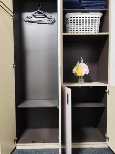 a closet with a door open with a vase of flowers at JKhouse5 in Fukuoka