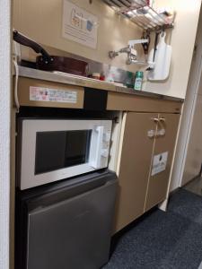 a kitchen with a microwave and a sink at JKhouse5 in Fukuoka +13 photos