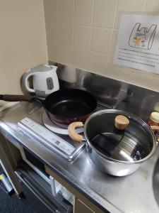 a frying pan sitting on a stove in a kitchen at JKhouse5 in Fukuoka