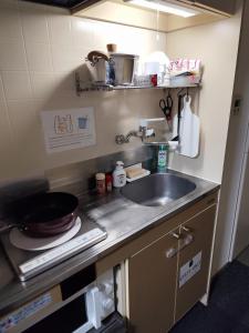 a kitchen with a sink and a counter top at JKhouse5 in Fukuoka
