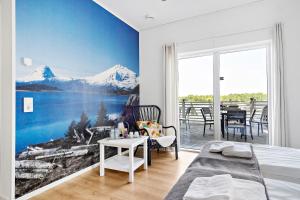 a bedroom with a mountain mural on the wall at First Camp Sjöstugan - Älmhult in Älmhult