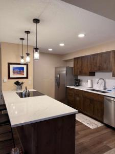 a kitchen with wooden cabinets and a white counter top at Cozy 2BDR with Stunning Location Near Town and Lifts in Breckenridge