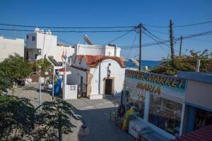 a small white building with a store in front of it at Harriet Beauty Studios in Haraki
