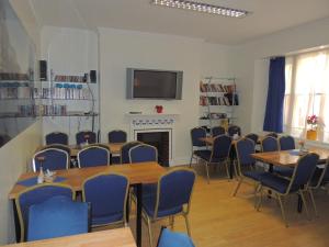 a conference room with tables and chairs and a tv at Dolphin Inn - The Lodge in London