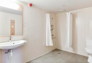 a bathroom with a sink and a toilet and a mirror at B&B HOTEL Toulouse Centre Canal du Midi in Toulouse +46 photos