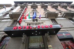 a sign on the front of a building with a north deno sign at Hotel Demo' in Milan