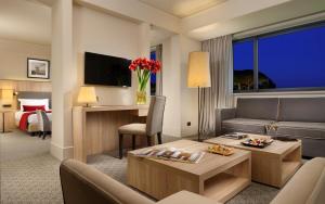 a hotel suite with a living room with a bed at A.Roma Lifestyle Hotel in Rome