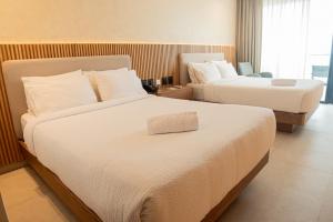 Ένα ή περισσότερα κρεβάτια σε δωμάτιο στο MantaHost Hotel