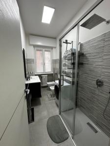 a bathroom with a shower and a toilet and a sink at Amazing Varese Central Apartment in Varese