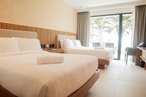Ένα ή περισσότερα κρεβάτια σε δωμάτιο στο MantaHost Hotel