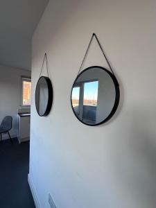 a mirror hanging on a wall next to a chair at Beautiful 1 Bd Top floor Terraced Apartment in Barking +10 photos