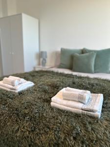 two towels are sitting on top of a rug at Beautiful 1 Bd Top floor Terraced Apartment in Barking